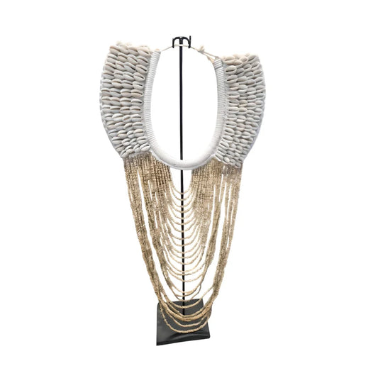 Collier décoratif en coquillages et perles sur socle beige